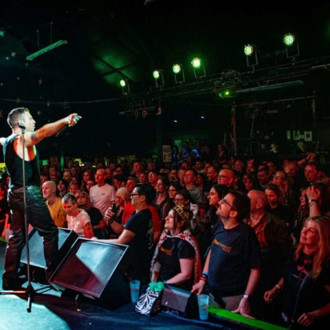 Singer pointing out at the crowd at Club 85