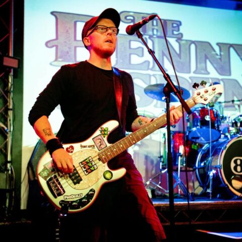 Bassist and drums under the lights